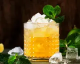 Enkla drinkar med rom, is och mynta. En uppfriskande drink med lime i bakgrunden.