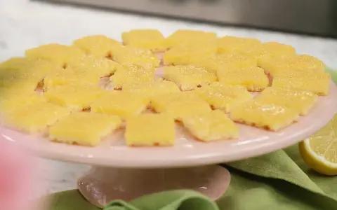 Fredriks fika: Citronrutor på ett rosa tårtfat, redo att avnjutas.